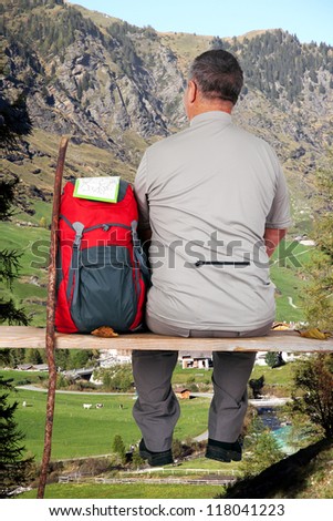 Man makes break from hiking and enjoying the view