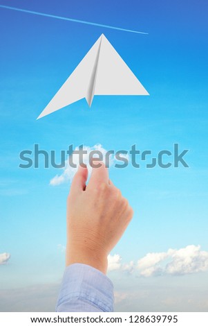 Hand throwing paper airplanes in the air