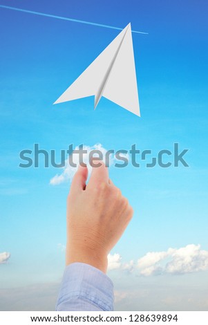 Hand throwing paper airplanes in the air
