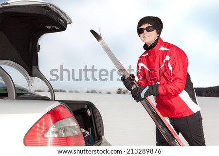 Woman with car and cross-country skis