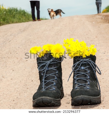 Front hiking boots and in the background people with dog