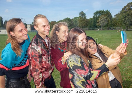 Adults young people make Selfie in the park