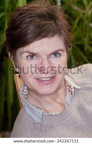 Casual woman sitting on the chair and smiling friendly