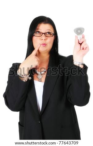 Woman thinking while holding a light bulb