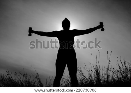 Fit female silhouette holding weights with arms stretched out