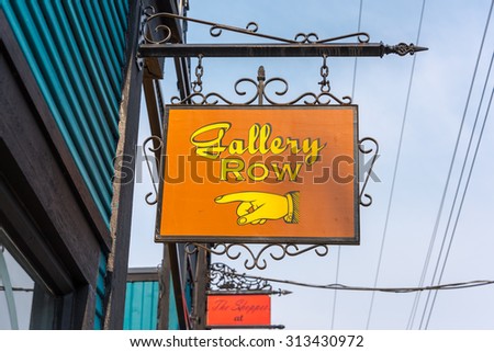 Nanaimo, British Columbia, Canada August 14, 2015 - Old style colorful shop signs hanging out front of stores in downtown Nanaimo on Vancouver Island, British Columbia, Canada.