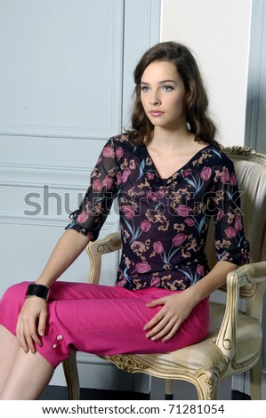 fashion model in fashion spring dress sitting chair posing
