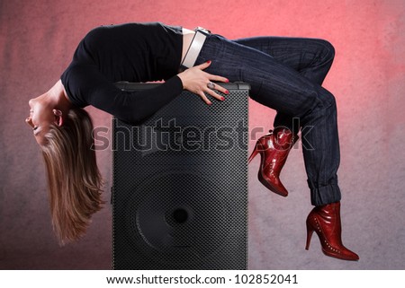 lady on laying on big speaker