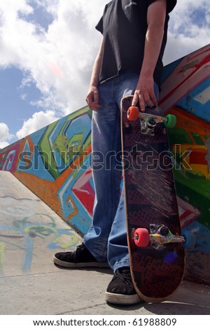 Skate Boarder holding his skate board in his hand at Limerick City Skate park