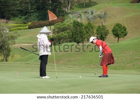 Hsin Chu- September 13th: a woman playing at a golf course in Taiwan golf course on September 13, 2014 in HsinChu,Taiwan