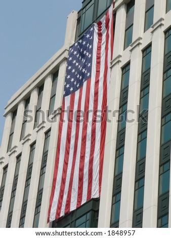 United States flags, hung during a sunny day, on the front side of buildings in Arlington, VA as a memorial to pay tribute to the victims and heros of 9-11.