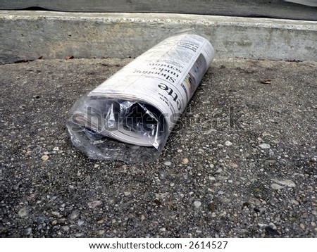 newspaper lying on front doorstep in a protective bag