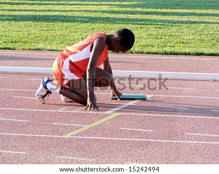 boys club track runner preparing for a relay race
