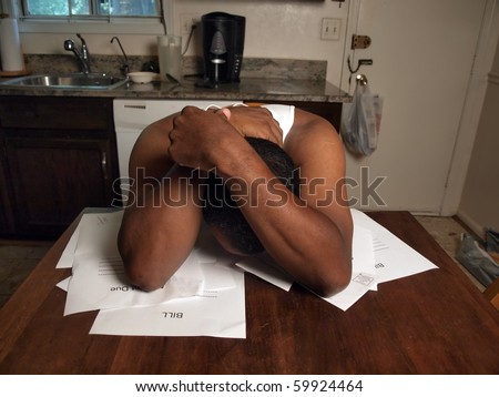 african american man holding his head as if under stress of his financial debt