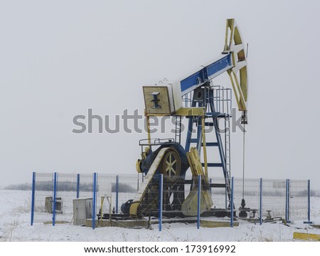 Operating oil and gas well isolated on snow white background