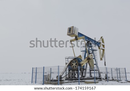 Operating oil and gas well isolated on white and grey background