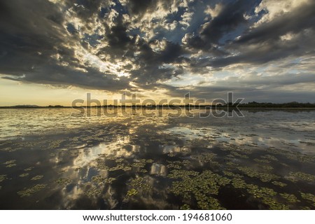 Ominous stormy sky reflection over natural lake