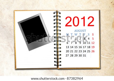 open note book with calendar 2012. Month is August.