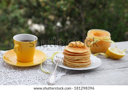 Pancakes with jam and tea. Breakfast of pancakes with lemon curd or a Kurd. Food style.