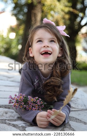 Adorable little girl laughing. Happy girl. A child without milk teeth. Toothless smile.
