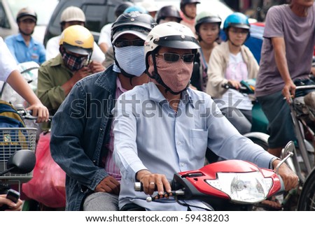 HO CHI MINH CITY, VIETNAM-AUGUST 20: men wearing face masks to protect from air pollution August 20, 2010 in Ho Chi Minh City.As Vietnam's economy has boomed, so too have pollution levels in HCMC.
