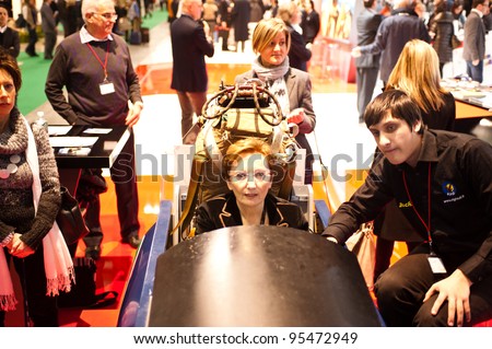 MILAN, ITALY - FEBRUARY 17: A visitor tries a a flight simulator at BIT International Tourism Exchange on february 17, 2012 in Milan, Italy.