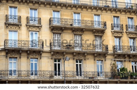 Color DSLR image of apartment building in Paris, France, with windows and balconies. Urban living and homes. Horizontal.