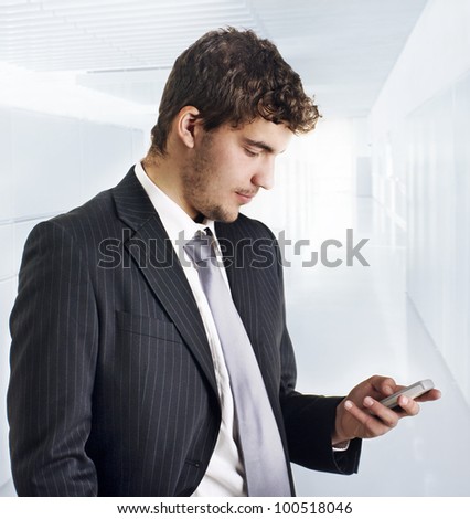 A young handsome business man on phone at office building