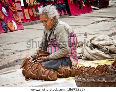 BHAKTAPUR, NEPAL - APR 5: Unidentified Nepalese woman working at the  pottery market, Apr 5, 2014 in Bhaktapur, Nepal.