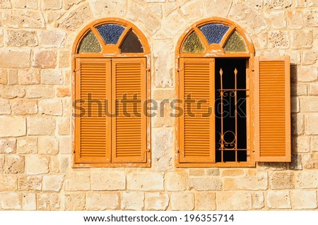 Two shuttered windows in stone wall of  Jaffa mosque.  Israel.