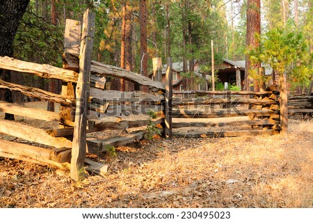 Wooden fence around house in forest of California.