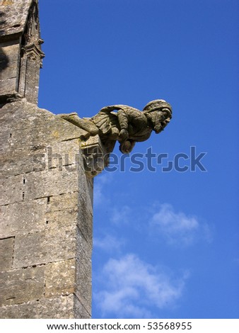 stone gargoyle on the side of a cathedral in france