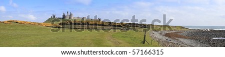 panorama of Dunstanburgh castle ruins on the northumberland coast of england