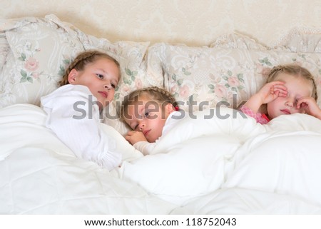 Adorable little girls sleepy in their bed