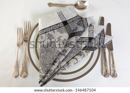 Antique silver cutlery and artistically folded napkins
