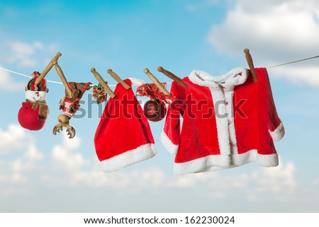 Santa clothes and christmas gifts hanging on a clothes line