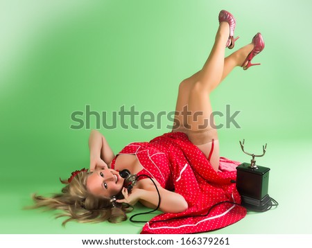 Blonde pin-up girl talking on a vintage telephone