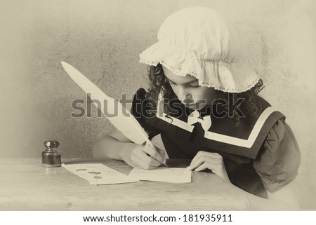 Young victorian girl in vintage dress and bonnet writing a letter