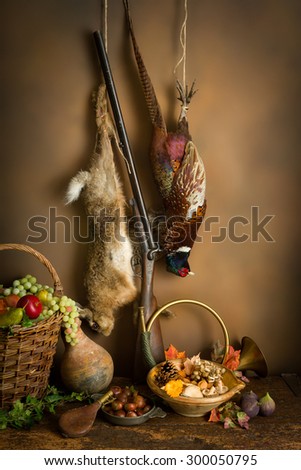 Autumn still life with hunting products, pheasant and hare