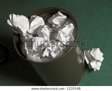 Waste paper basket, full of paper balls