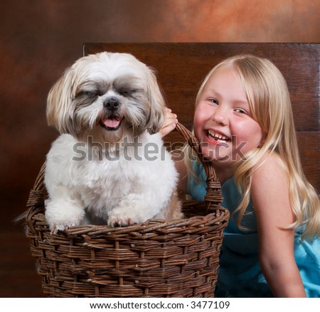 Little blond girl and her dog, both with a big smile