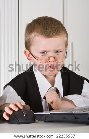 Four year old boy playing angry director in his office