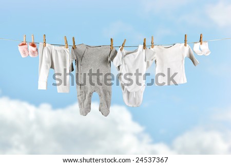 Baby laundry hanging in the sky on a clothesline