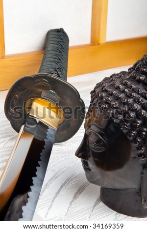 Japanese samurai sword and buddha against a shoji sliding window