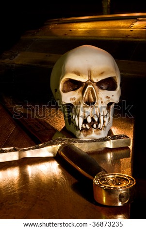 Medieval sword and spooky skull lit by candles