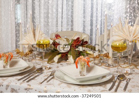 Elegant Christmas or Wedding table with flower arrangement and prawn cocktail