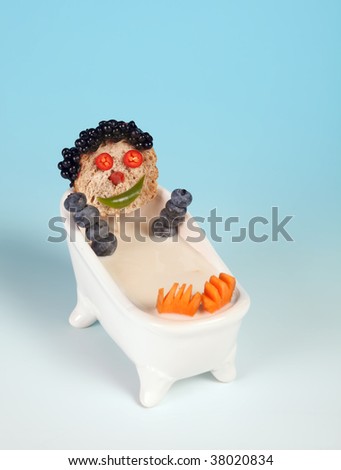 Funny food face in a bathtub full of milk