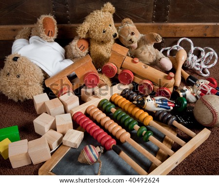 Abandoned old toys against an antique wooden chest