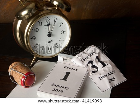 Alarm clock and calendar showing the beginning of New Year