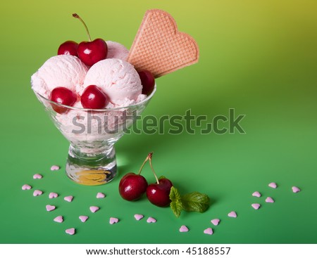 Ice cream sundae with cherries, biscuits and sugar hearts
